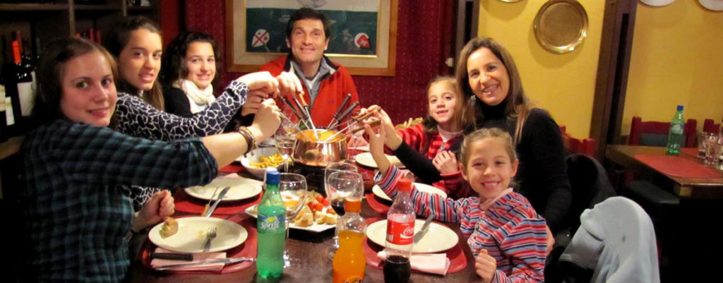 Particiant eating dinner with host family