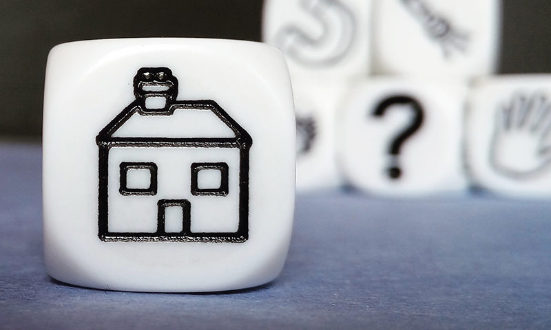 An image of a house on a cube.