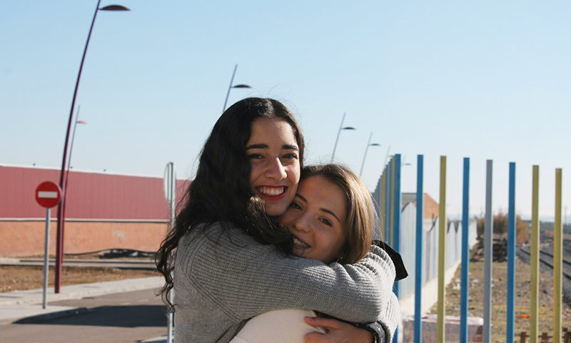 Two friends embracing in Spain.