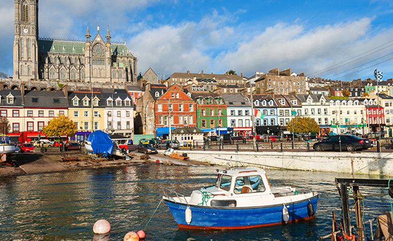 A colorful boat and buildings at the harbor in Cork, Ireland.