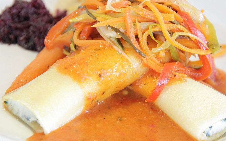 Cannoli pasta with colorful toppings.