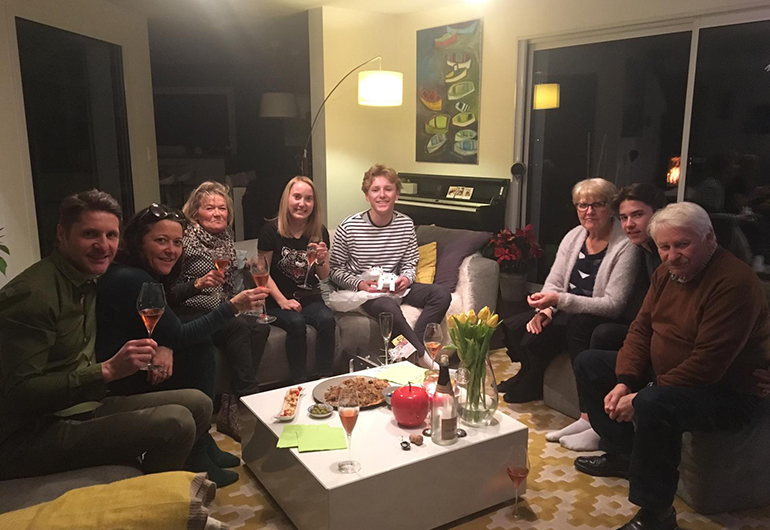 Ian and his host family in France enjoying a meal and wine together.